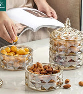 Elegant glass snack bowls with diamond-cut design, holding nuts and snacks for modern kitchen storage.